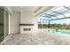 Covered lanai features a modern fireplace and is open to the screened-in pool and spa at 8376 Sea Glass Ct, Sarasota, FL 34240