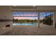 Covered lanai features a fireplace and view of the screened-in pool and relaxing spa at 8376 Sea Glass Ct, Sarasota, FL 34240