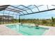Inviting screened-in pool and spa overlooking the beautiful landscape under a partly cloudy blue sky at 8376 Sea Glass Ct, Sarasota, FL 34240