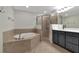 Bathroom boasts a soaking tub, shower, and double vanity at 8402 Grand Estuary Trl # 101, Bradenton, FL 34212