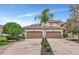 Two story townhome exterior, featuring a double-car garage and landscaped walkway at 8402 Grand Estuary Trl # 101, Bradenton, FL 34212