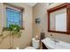 Small bathroom with sink, toilet and decorative mirror at 8889 White Sage Loop, Lakewood Ranch, FL 34202