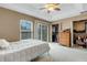 Bright bedroom with a ceiling fan, walk-in closets and sliding door access at 8889 White Sage Loop, Lakewood Ranch, FL 34202