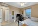 Bedroom with a bed, desk, and window at 8889 White Sage Loop, Lakewood Ranch, FL 34202
