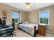 Bedroom with a bed, desk, and window at 8889 White Sage Loop, Lakewood Ranch, FL 34202