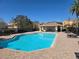 A clean community pool is surrounded by a secure fence, lounge chairs, and a pool house at 8889 White Sage Loop, Lakewood Ranch, FL 34202