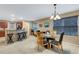 Bright dining room with glass table and chairs, kitchen and living room views at 8889 White Sage Loop, Lakewood Ranch, FL 34202