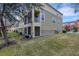 Exterior view of townhome with grassy backyard at 8889 White Sage Loop, Lakewood Ranch, FL 34202