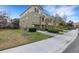 Multi-story townhome featuring a one car garage, manicured lawn, and tidy landscaping at 8889 White Sage Loop, Lakewood Ranch, FL 34202