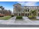 Exterior view of a two-story townhome with a two-car garage and landscaped front yard at 8889 White Sage Loop, Lakewood Ranch, FL 34202