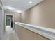 Upper level hallway leading to bedrooms and balcony at 8889 White Sage Loop, Lakewood Ranch, FL 34202