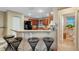 Kitchen bar area with seating, stainless steel appliances, and view of the bathroom at 8889 White Sage Loop, Lakewood Ranch, FL 34202