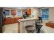 Kitchen with wood cabinets, a breakfast bar, and tile flooring at 8889 White Sage Loop, Lakewood Ranch, FL 34202