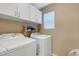 Laundry room with washer, dryer, and cabinets at 8889 White Sage Loop, Lakewood Ranch, FL 34202