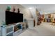 Living area features a large TV and views into the kitchen and dining areas at 8889 White Sage Loop, Lakewood Ranch, FL 34202