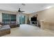 Spacious living room with sliding doors to balcony and plush gray sectional at 8889 White Sage Loop, Lakewood Ranch, FL 34202