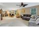 Spacious living room with sectional sofa, Christmas tree, and view of dining area at 8889 White Sage Loop, Lakewood Ranch, FL 34202