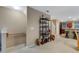 Open living room with a staircase, built-in shelving, and view into the kitchen at 8889 White Sage Loop, Lakewood Ranch, FL 34202