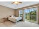 Bedroom with a balcony, natural light, and neutral colors at 8889 White Sage Loop, Lakewood Ranch, FL 34202