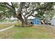 Large backyard with mature oak tree and a detached shed at 1006 69Th W Ave, Bradenton, FL 34207