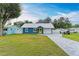 Charming blue house with a green door and well-manicured lawn at 1006 69Th W Ave, Bradenton, FL 34207