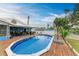 Inviting in-ground pool with wooden deck at 1006 69Th W Ave, Bradenton, FL 34207