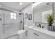 Modern bathroom with a glass shower, marble vanity, and black fixtures at 14146 Cattle Egret Pl, Bradenton, FL 34202
