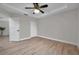 Simple bedroom with light walls, wood flooring, and ceiling fan at 14146 Cattle Egret Pl, Bradenton, FL 34202