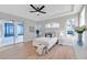 Main bedroom with large windows, ceiling fan and access to the patio at 14146 Cattle Egret Pl, Bradenton, FL 34202