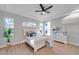 Bright bedroom with a ceiling fan and access to a patio at 14146 Cattle Egret Pl, Bradenton, FL 34202
