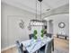 Bright dining room with marble table, modern chandelier, and hardwood floors at 14146 Cattle Egret Pl, Bradenton, FL 34202