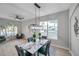 Modern dining room with marble table, light gray walls, and hardwood floors at 14146 Cattle Egret Pl, Bradenton, FL 34202