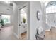 Bright and airy entryway with a bench, powder room, and staircase at 14146 Cattle Egret Pl, Bradenton, FL 34202
