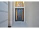 Modern dark gray front door with sidelights, welcoming entryway at 14146 Cattle Egret Pl, Bradenton, FL 34202
