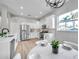 Modern kitchen with white cabinets, stainless steel appliances and breakfast bar at 14146 Cattle Egret Pl, Bradenton, FL 34202