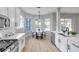 Eat-in kitchen with white cabinets, stainless steel appliances, and breakfast nook at 14146 Cattle Egret Pl, Bradenton, FL 34202
