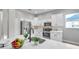 Kitchen island with sink, quartz countertop, and a fruit bowl at 14146 Cattle Egret Pl, Bradenton, FL 34202