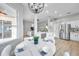 Kitchen with round table for four, white cabinets, and view to living room at 14146 Cattle Egret Pl, Bradenton, FL 34202