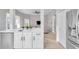 Modern kitchen with white cabinets, island, and stainless steel appliances at 14146 Cattle Egret Pl, Bradenton, FL 34202