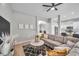 Living room with sectional sofa, coffee table, and view into kitchen at 14146 Cattle Egret Pl, Bradenton, FL 34202