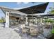 Outdoor bar and lounge area with umbrellas at 16606 San Nicola Pl, Lakewood Ranch, FL 34211