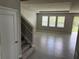 Open living area with tile floors and access to stairs at 17637 Cantarina Cv, Bradenton, FL 34211