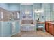 Elegant bathroom with a soaking tub, shower, and double vanity at 210 166Th Ne St, Bradenton, FL 34212