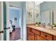 Bathroom with granite countertop, wood cabinets, and a view of bedroom at 210 166Th Ne St, Bradenton, FL 34212
