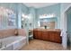 Spa-like bathroom with a soaking tub and double vanity at 210 166Th Ne St, Bradenton, FL 34212