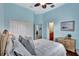 Bedroom with double bed, light blue walls, and wood floors at 210 166Th Ne St, Bradenton, FL 34212