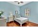 Light blue bedroom with wood floors, a queen bed, and white dresser at 210 166Th Ne St, Bradenton, FL 34212