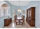 Formal dining room with dark wood furniture and a chandelier at 210 166Th Ne St, Bradenton, FL 34212