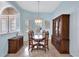 Formal dining area with dark wood furniture and a light blue color scheme at 210 166Th Ne St, Bradenton, FL 34212