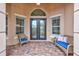 Covered entryway with double doors and wicker seating at 210 166Th Ne St, Bradenton, FL 34212